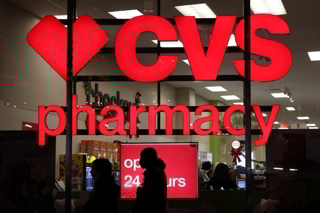 People walk by a CVS pharmacy store in Manhattan, New York City, New York, U.S., November 17, 2021. REUTERS/Andrew Kelly/File photo