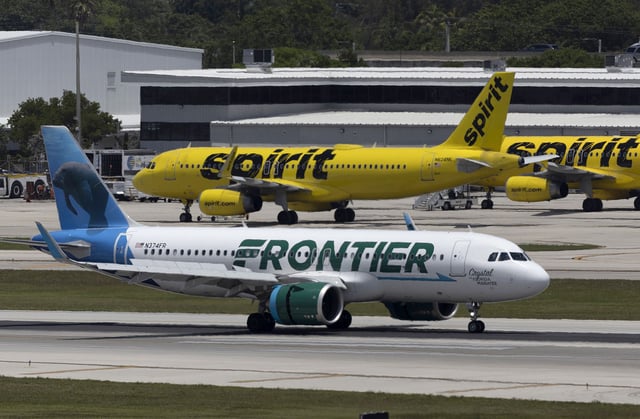FORT LAUDERDALE, FLORIDA - MAY 16: A Frontier Airlines plane near a Spirit Airlines plane at the Fort Lauderdale-Hollywood International Airport on May 16, 2022 in Fort Lauderdale, Florida. JetBlue announced it is taking a hostile position in its effort to acquire Spirit Airlines. Spirit previously rejected a takeover offer from JetBlue, favoring an earlier deal to merge with Frontier airlines. (Photo by Joe Raedle/Getty Images)