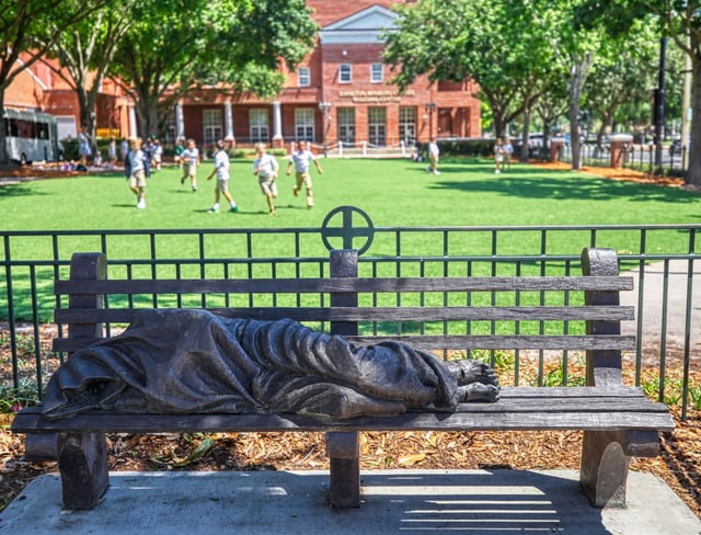 Sculpture of Jesus on a bench outside a filed at The Christ School at the First Presbyterian Church of Orlando in downtown Orlando, on Monday, May 20, 2024.  
(Ricardo Ramirez Buxeda/ Orlando Sentinel)