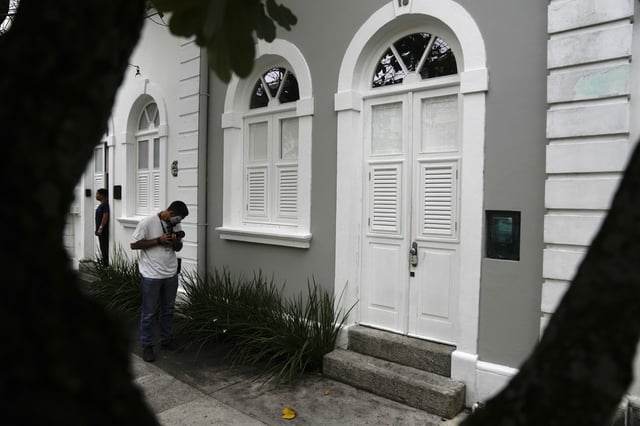 A journalist outside of the entrance to the apartment where Brent Sikkema was found dead, in Rio de Janeiro, Brazil, Thursday, Jan. 18, 2024.