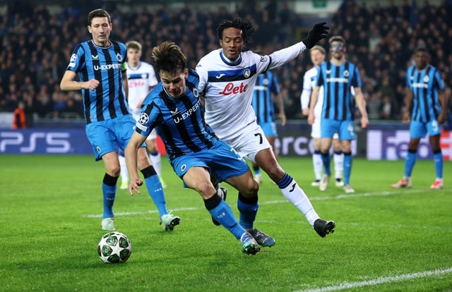 Soccer Football - Champions League - Knockout Phase Playoff - First Leg - Club Brugge v Atalanta - Jan Breydel Stadium, Bruges, Belgium - February 12, 2025 Club Brugge's Ardon Jashari in action with Atalanta's Juan Cuadrado REUTERS/Yves Herman