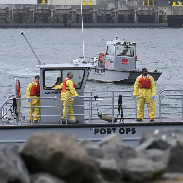 U.S. Navy boats work along the shore near Shelter Island after a U.S. Navy plane crashed into the San Diego Bay, Wednesday, Feb. 12, 2025, in San Diego. (AP Photo/Denis Poroy)