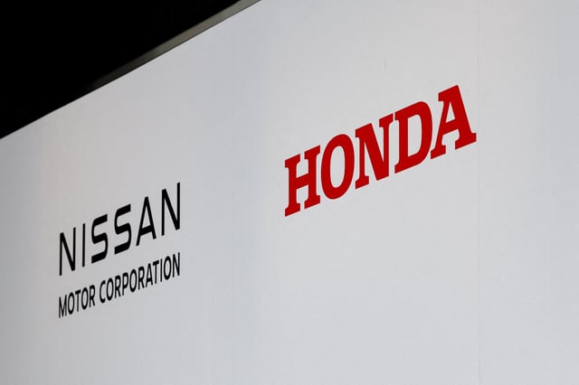 Logos of Nissan Motor Corporation and Honda are seen at a joint press conference on their merger talks, in Tokyo, Japan, December 23, 2024. REUTERS/Kim Kyung-Hoon/File Photo