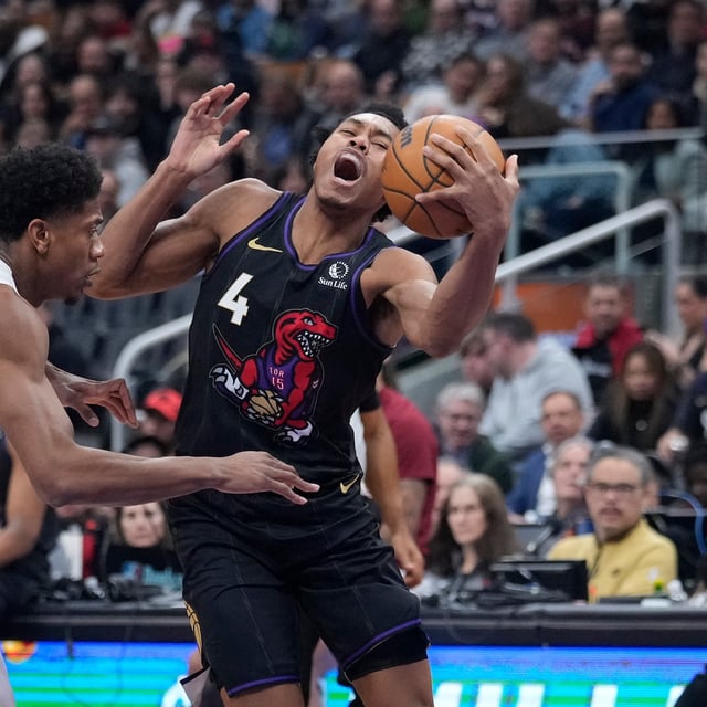 Feb 12, 2025; Toronto, Ontario, CAN; Toronto Raptors forward Scottie Barnes (4) battles to get around Cleveland Cavaliers forward De'Andre Hunter (12) during the first half at Scotiabank Arena. Mandatory Credit: John E. Sokolowski-Imagn Images