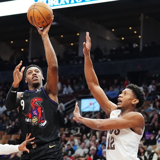 Toronto Raptors' RJ Barrett (9) shoots between Cleveland Cavaliers' Donovan Mitchell (left) and De'Andre Hunter during second half NBA basketball action in Toronto on Wednesday, February 12, 2025. THE CANADIAN PRESS/Frank Gunn
