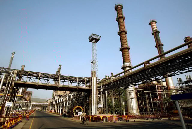 A worker rides a bicycle at the Bharat Petroleum Corporation Ltd. refinery in Mumbai April 24, 2008. REUTERS/Punit Paranjpe/File Photo