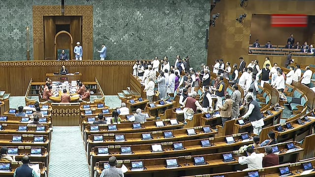 Members protest in the Lok Sabha during the Budget session of Parliament, in New Delhi, Thursday, Feb. 13, 2025.