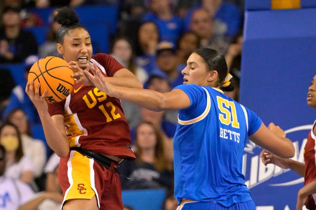 USC Trojans guard JuJu Watkins (12) keeps the ball from UCLA Bruins center Lauren Betts (51) in the second half at Pauley Pavilion presented by Wescom.