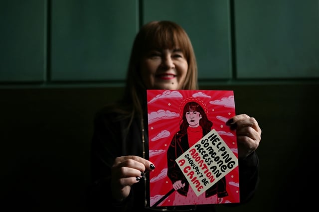 Polish pro-choice activist Justyna Wydrzynska shows a postcard from her supporters prior to her verdict announcement at the appeals court.