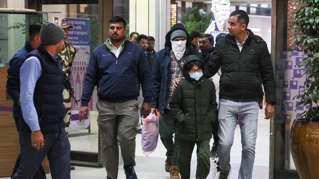 Security personnel escort Indian immigrants deported from the U.S., as they leave the airport in Ahmedabad, India. (file)