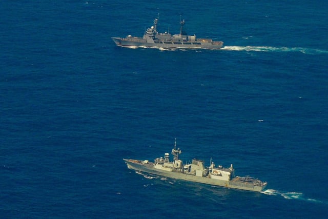 Philippine Gregorio del Pilar-class offshore patrol vessel the BRP Andres Bonifacio (left) and Canadian Halifax-class frigate the HMCS Ottawa sail during a multilateral maritime cooperative activity on February 12 within the Philippines&#39; exclusive economic zone.
