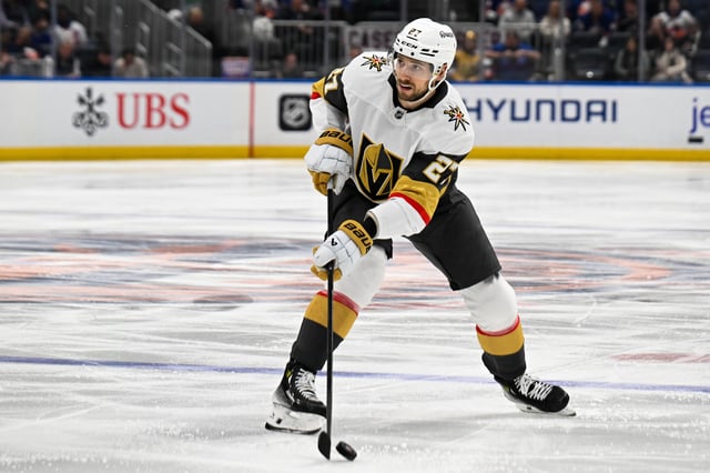 Feb 4, 2025; Elmont, New York, USA;  Vegas Golden Knights defenseman Shea Theodore (27) skates with the puck against the New York Islanders during the third period at UBS Arena. Mandatory Credit: Dennis Schneidler-Imagn Images/File Photo
