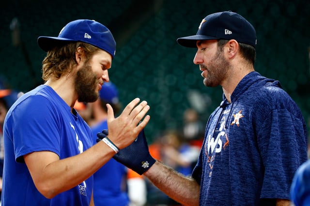 Clayton Kershaw #22 of the Los Angeles Dodgers shakes hands with Justin Verlander #35 of the Houston Astros before game three of the 2017 World Series at Minute Maid Park on October 27, 2017 in Houston, Texas.