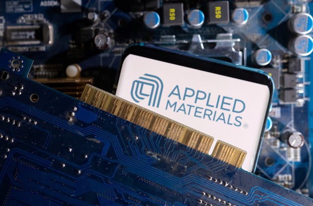 A smartphone with a displayed Applied Materials logo is placed on a computer motherboard in this illustration taken March 6, 2023. REUTERS/Dado Ruvic/Illustration/File Photo