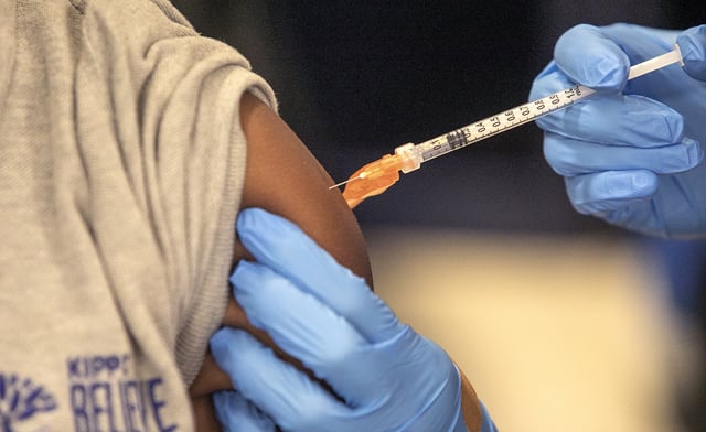 FILE - Medical personnel vaccinate students at a school in New Orleans on Jan. 25, 2022. (AP Photo/Ted Jackson, File)