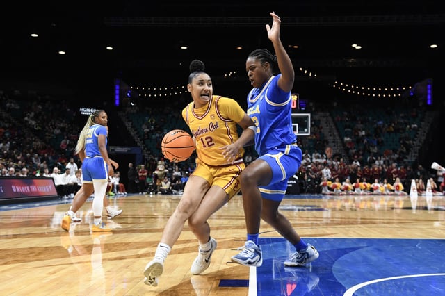 JuJu Watkins #12 of the USC Trojans drives past Christeen Iwuala #22 of the UCLA Bruins in the first half of a semifinal game of the Pac-12 Conference women&#39;s basketball tournament at MGM Grand Garden Arena on March 08, 2024 in Las Vegas, Nevada.