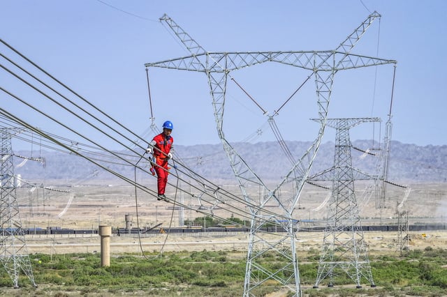 A worker installing electricity transmission lines in Korla, in China&#39;s northwestern Xinjiang region.