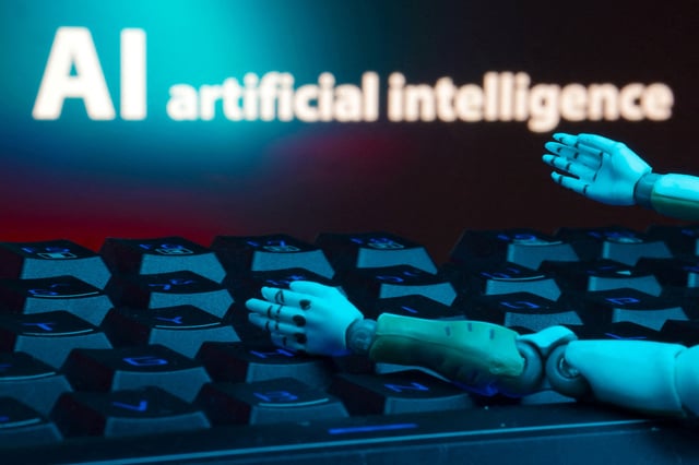A message reading "AI artificial intelligence", a keyboard, and robot hands are seen in this illustration taken January 27, 2025. REUTERS/Dado Ruvic/Illustration/File Photo