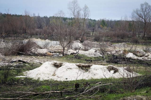FILE - Russian trenches and firing positions sit in the highly contaminated soil adjacent to the Chernobyl nuclear power plant near Chernobyl, Ukraine, April 16, 2022. (AP Photo/Efrem Lukatsky, File)