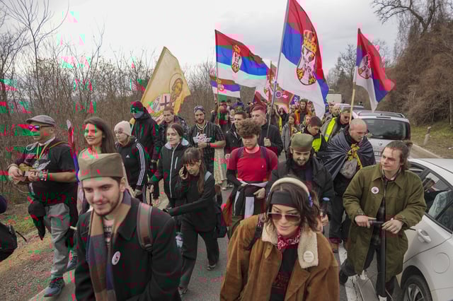 Students march trough the fields near the village of Cumic near the Serbian industrial town of Kragujevac, to protest the deaths of 15 people killed in the November collapse of a train station canopy, Friday, Feb. 14, 2025. (AP Photo/Darko Vojinovic)