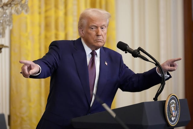 President Donald Trump points to a reporter and India's Prime Minister Narendra Modi during a news conference in the East Room of the White House, Thursday, Feb. 13, 2025, in Washington. (AP Photo/Ben Curtis)