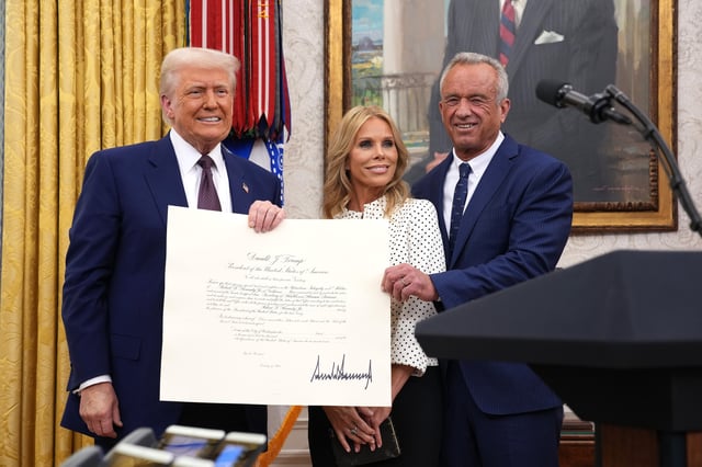 At a White House ceremony on Feb. 13, 2025, President Donald Trump presents a commission certificate to new Health and Human Services Secretary Robert F. Kennedy Jr. and his wife, actress Cheryl Hines.