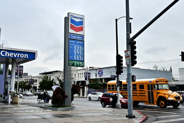 A school bus passes a petrol station where a gallon of gasoline is going for over $5 a gallon on Feb. 12, 2025, in Los Angeles. 