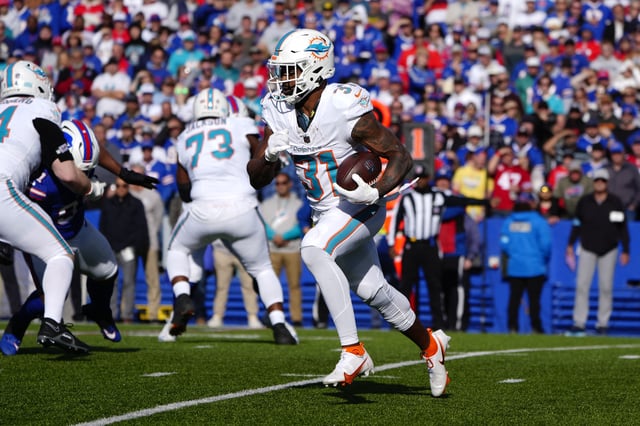 Nov 3, 2024; Orchard Park, New York, USA; Miami Dolphins running back Raheem Mostert (31) runs with the ball against the Buffalo Bills during the first half at Highmark Stadium. Mandatory Credit: Gregory Fisher-Imagn Images/File Photo