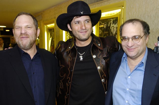 FILE — Miramax co-founders Harvey Weinstein, left, and his brother Bob Weinstein, right, pose with "Sin City" co-director Robert Rodriguez, March 28, 2005 in Los Angeles. (AP Photo/Chris Pizzello. File)