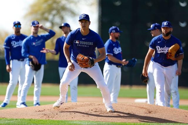 Shohei Ohtani #17 of the Los Angeles Dodgers participates in a fielding drill during spring training workouts at Camelback Ranch on February 14, 2025 in Glendale, Arizona.