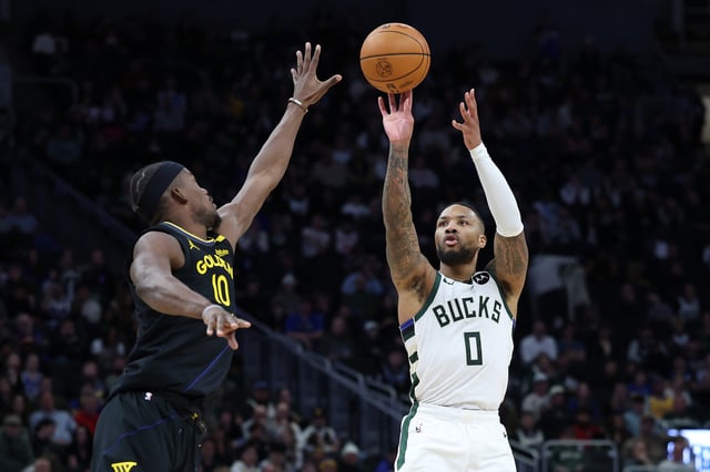 Damian Lillard #0 of the Milwaukee Bucks shoots over Jimmy Butler #10 of the Golden State Warriors during the second half of a game at Fiserv Forum on February 10, 2025 in Milwaukee, Wisconsin.