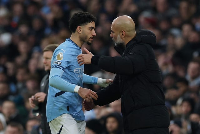 Soccer Football - Premier League - Manchester City v Newcastle United - Etihad Stadium, Manchester, Britain - February 15, 2025 Manchester City's Omar Marmoush with manager Pep Guardiola after being substituted REUTERS/Phil Noble