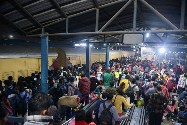 People, including Hindu pilgrims on their way to attend the "Maha Kumbh Mela", or the Great Pitcher Festival, gather at the New Delhi Railway Station to board a train in New Delhi, India, February 15, 2025. REUTERS/Stringer