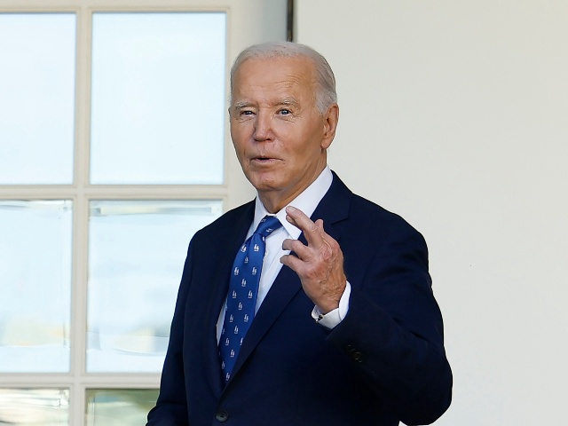 WASHINGTON, DC - NOVEMBER 26: U.S. President Joe Biden crosses his fingers as he responds to a question about middle east peace after delivering remarks from the Rose Garden at the White House on November 26, 2024 in Washington, DC. Biden spoke on the ceasefire agreement between Israel and Hezbollah. (Photo by Kevin Dietsch/Getty Images)
