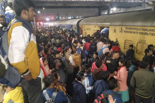 Passengers jostle to board a train at the railway station in New Delhi, India, on Feb.15, 2025.