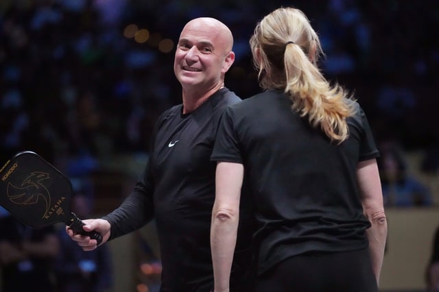 Andre Agassi and Steffi Graf acknowledge fans during Pickleball Slam 2 at Hard Rock Live at Seminole Hard Rock Hotel & Casino.