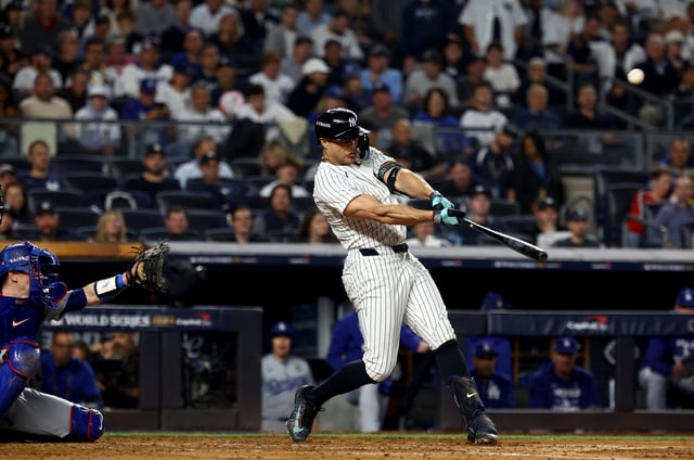 Oct 30, 2024; New York, New York, USA; New York Yankees designated hitter Giancarlo Stanton (27) hits a home run during the third inning against the Los Angeles Dodgers in game five of the 2024 MLB World Series at Yankee Stadium. Mandatory Credit: Vincent Carchietta-Imagn Images/File Photo