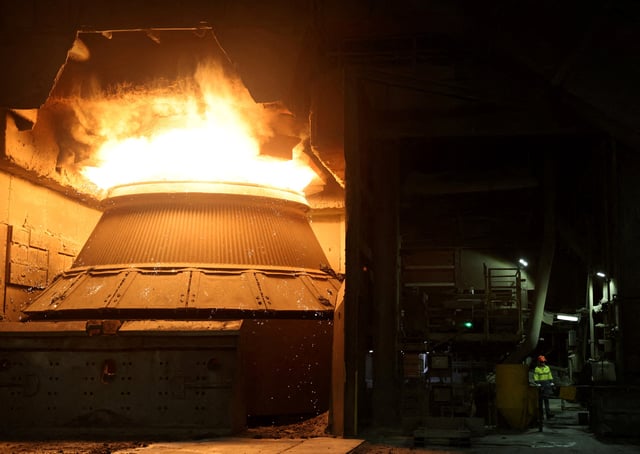 A worker stands next to a furnace at the BlueScope steelworks, Port Kembla, Australia February 9, 2024. REUTERS/Lewis Jackson/File Photo