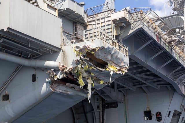 Exterior damage to the aircraft carrier USS Harry S. Truman viewed from a ship’s rigid-hull inflatable boat following a collision with merchant vessel on February 12 off Egypt.