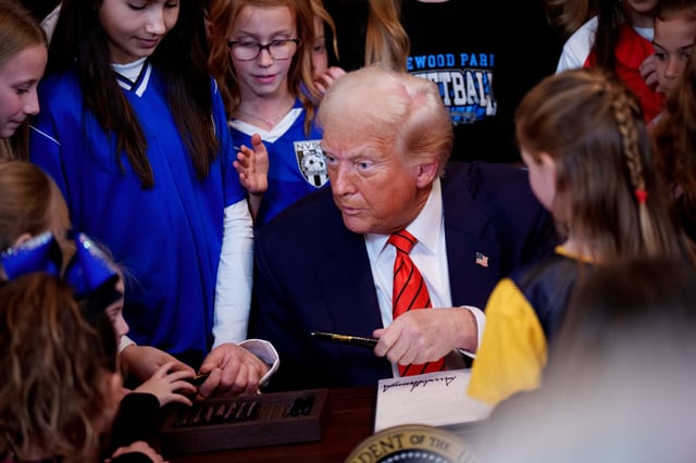 U.S. President Donald Trump hands out pens to girls after signing the &#34;No Men in Women&#39;s Sports&#34; executive order on February 5, 2025 in Washington, DC, one of several anti-transgender orders Trump has signed since taking office.