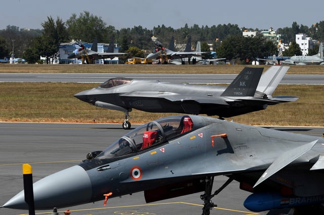 A F-35 fighter jet moves past Indian Air Force's Sukhoi Su-30MKI fighter jet parked on tarmac during the "Aero India 2025" air show at Yelahanka air base in Bengaluru, India, February 11, 2025. REUTERS/Stringer/File Photo