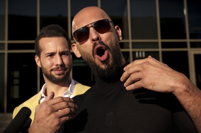 Andrew Tate gestures, next to his brother Tristan, outside the Bucharest Tribunal in Bucharest, Romania, Thursday, January 9, 2025.
