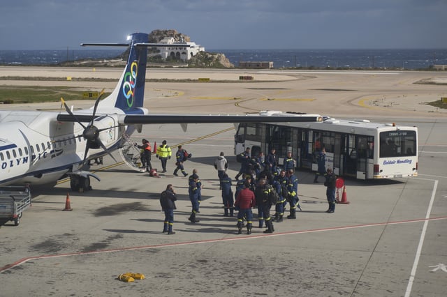 Fire service rescuers arrive at the airport of the earthquake-hit island of Santorini, Greece, on Wednesday, Feb. 5, 2025. (AP Photo/Petros Giannakouris)