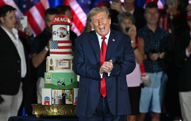 Donald Trump gestures by his birthday cake, created by Club 47, during a campaign rally as he celebrates his 78th birthday at West Palm Convention Center, in West Palm Beach, Florida, on June 14, 2024.