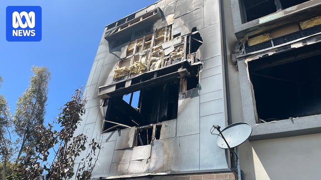 A blackened window with insulation exposed.