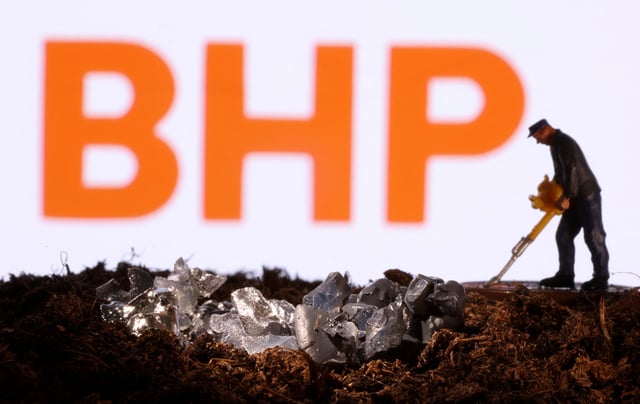 A small toy figure and mineral imitation are seen in front of the BHP logo in this illustration taken November 19, 2021. REUTERS/Dado Ruvic/Illustration/File Photo