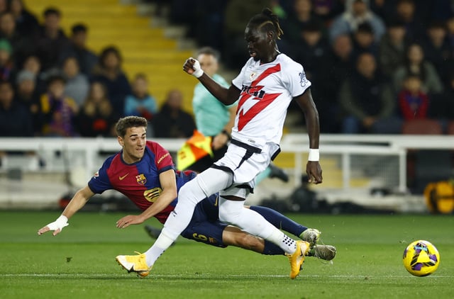 Soccer Football - LaLiga - FC Barcelona v Rayo Vallecano - Estadi Olimpic Lluis Companys, Barcelona, Spain - February 17, 2025 Rayo Vallecano's Pathe Ciss in action with FC Barcelona's Gavi REUTERS/Albert Gea