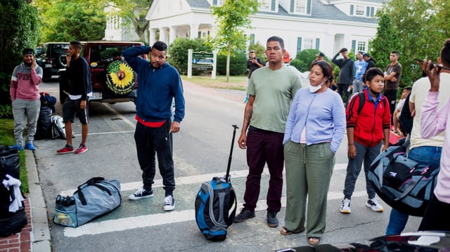 Migrants, who arrived on a flight sent by Florida Gov. Ron DeSantis, gather with their belongings outside St. Andrews Episcopal Church in Edgartown, Mass., on Martha&#39;s Vineyard. The DeSantis administration contracted with Vertol Systems Company, Inc. to transport two planeloads of migrants on Sept. 14, 2022, from San Antonio, Texas, to Martha&#39;s Vineyard, with a stop in the Northwest Florida community of Crestview. (Ray Ewing/Vineyard Gazette via AP, File)