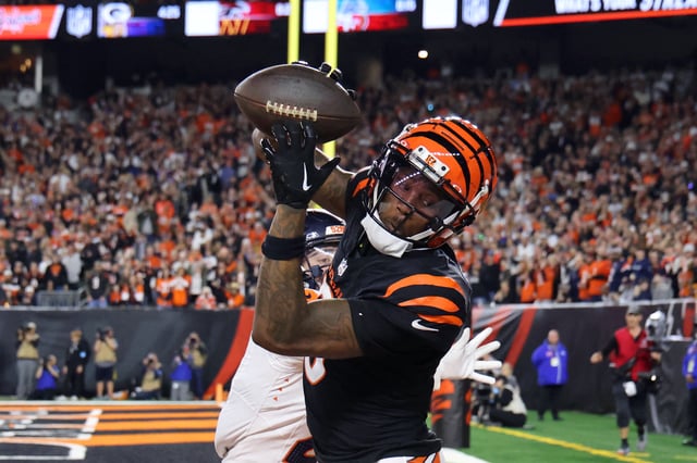 Dec 28, 2024; Cincinnati, Ohio, USA;  Cincinnati Bengals  wide receiver Tee Higgins (5) catches a touchdown as Denver Broncos cornerback Riley Moss (21) defends during the fourth quarter at Paycor Stadium. Joseph Maiorana-Imagn Images/File Photo