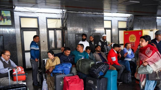 Passengers wait on platform with their luggage after the stampede. (ANI)